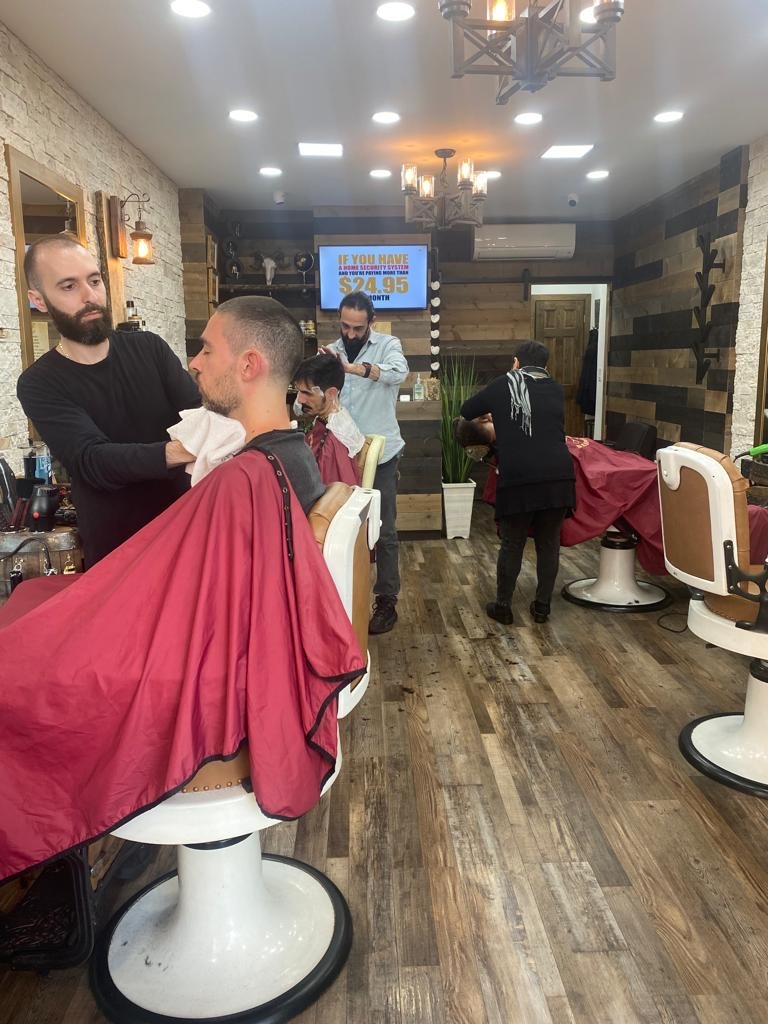 How should a barber shop handle bloodborne pathogens and potential exposure risks?