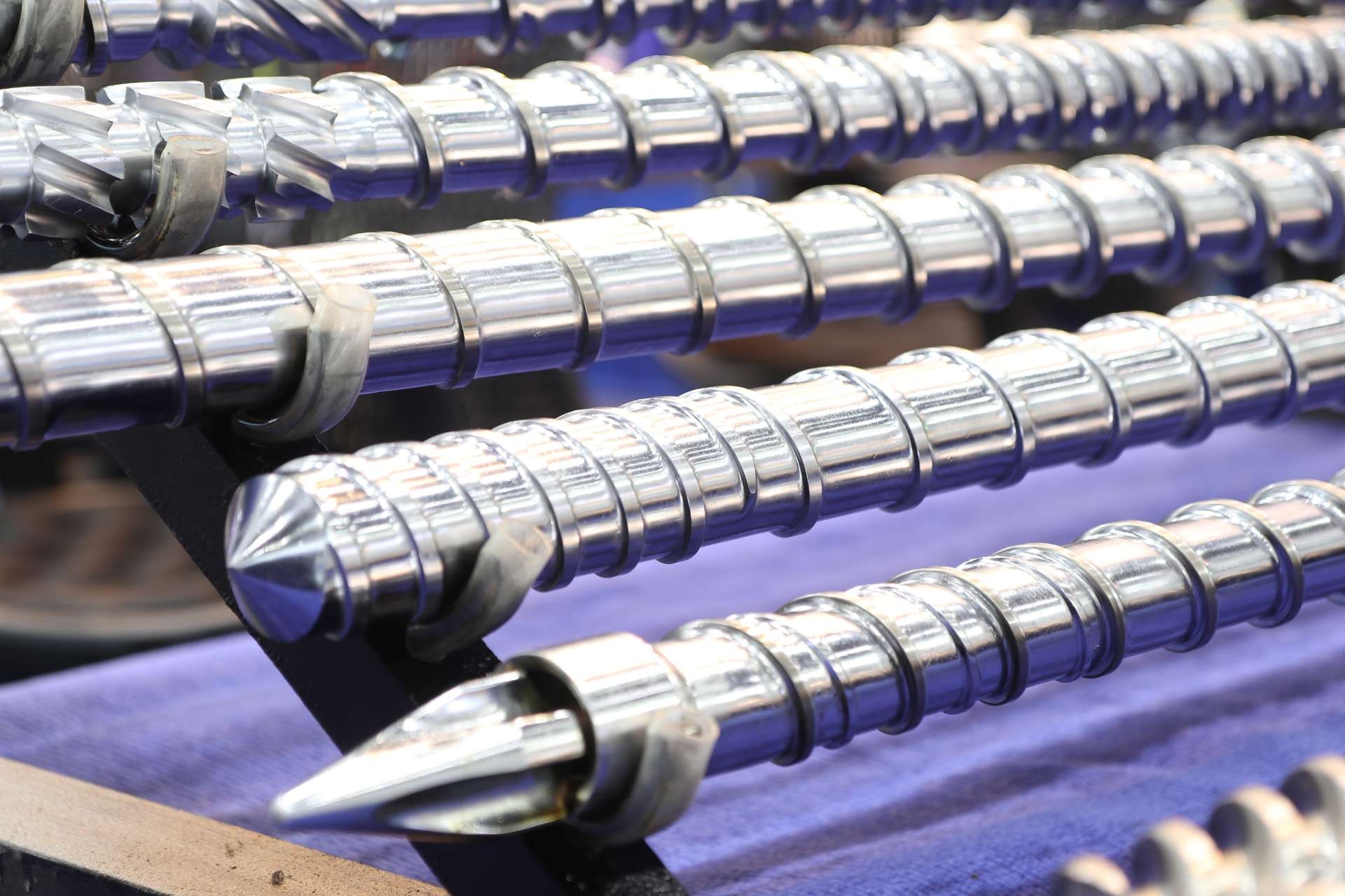 Can surface treatments such as nitriding or coating help prevent surface fatigue in ball screws?