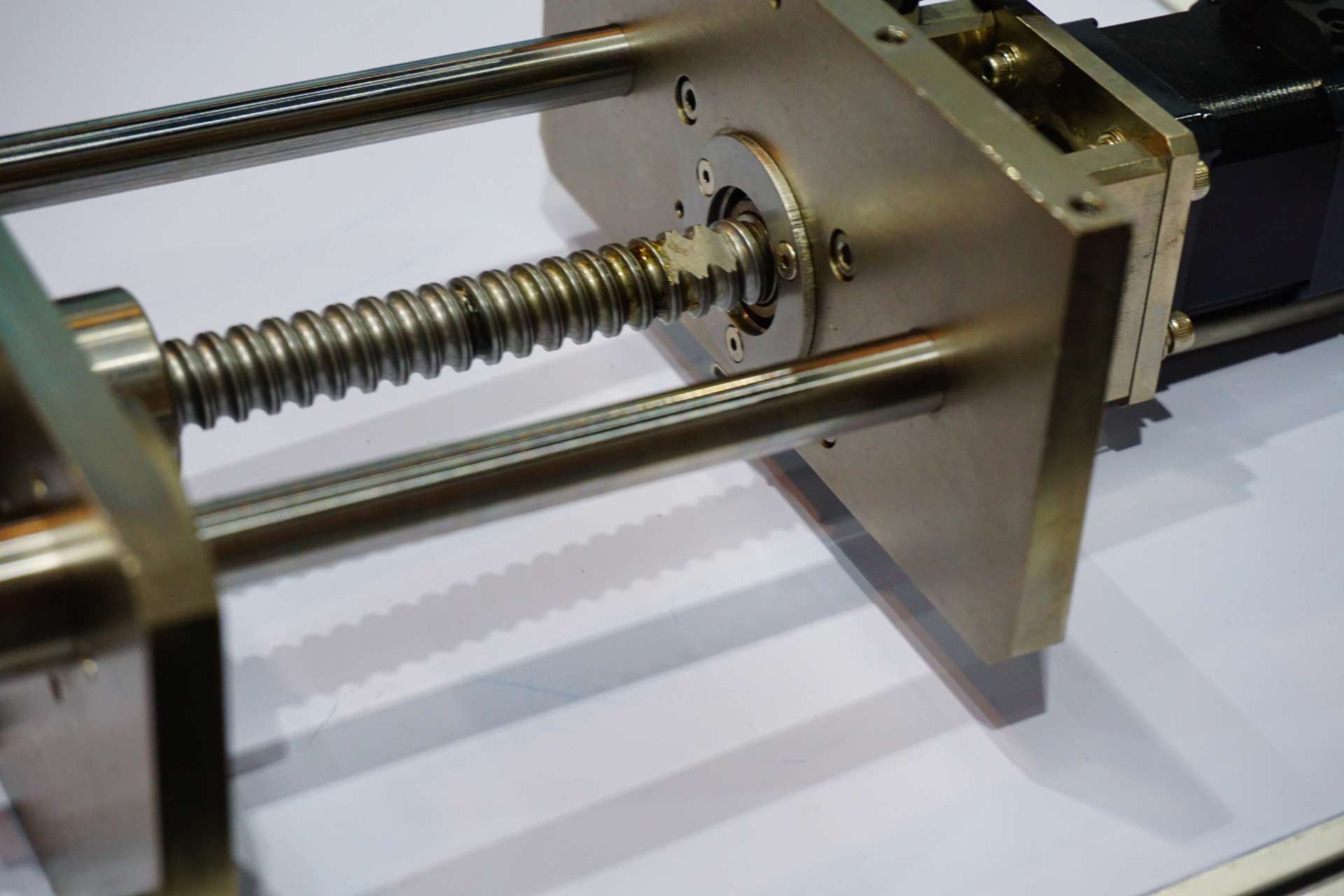 Can the material and surface finish of the ball screw components impact the friction coefficient?