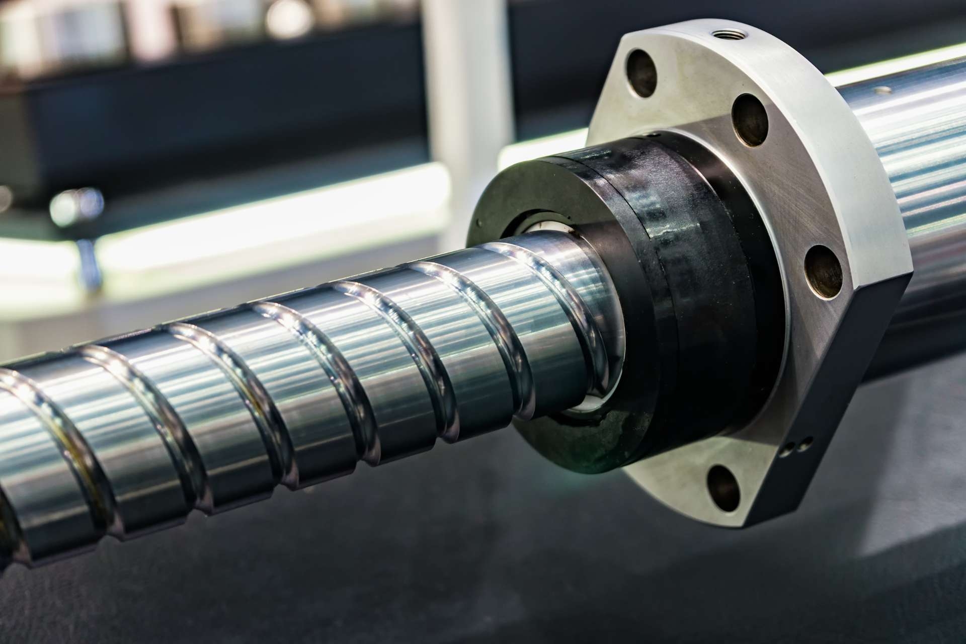 How does lubrication impact load distribution and overall performance in ball screws?