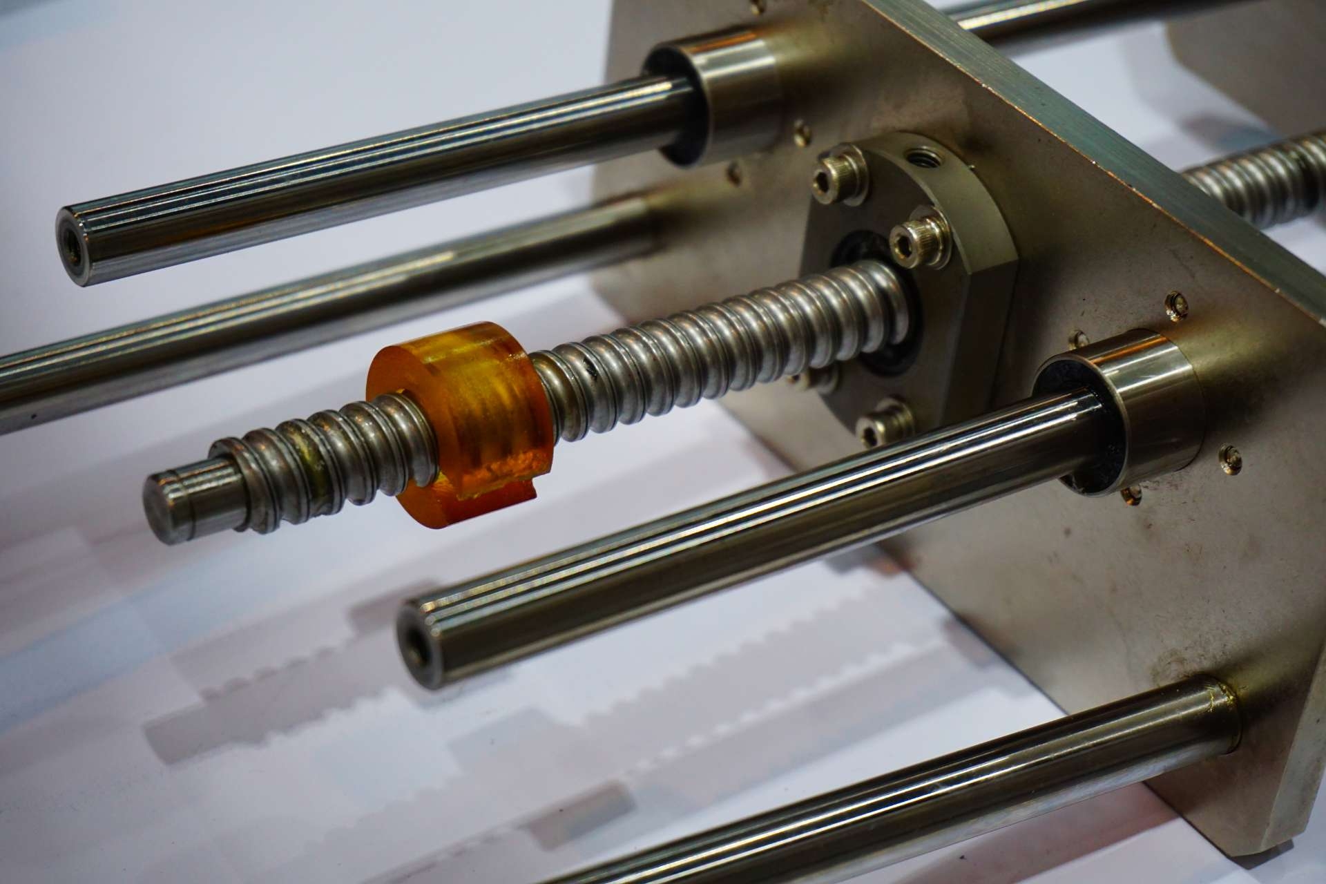 What materials are commonly used in ball screws to minimize the effects of thermal expansion?