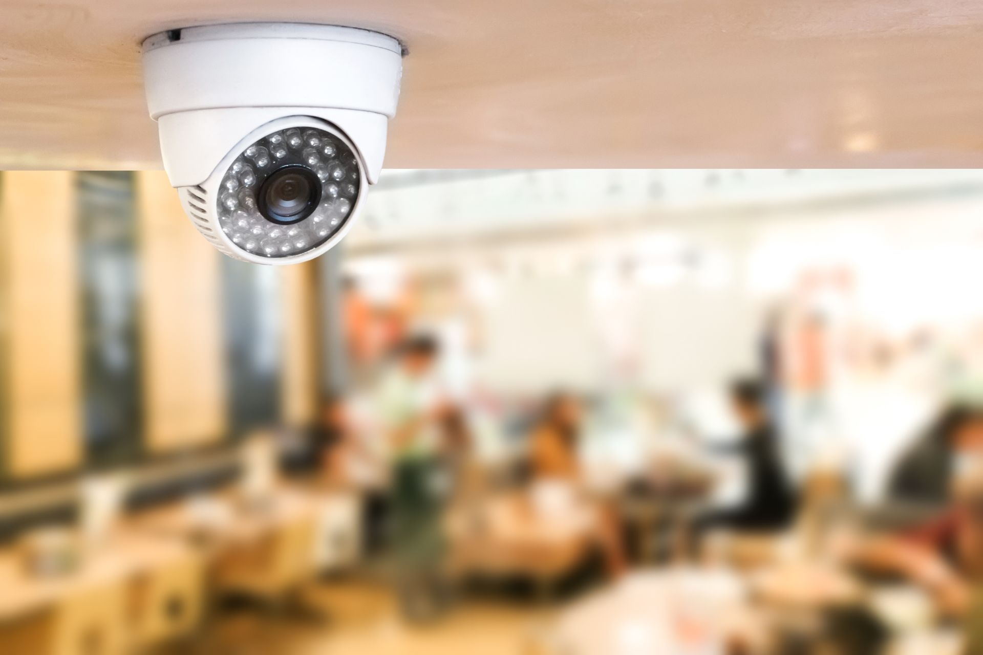 How can businesses effectively monitor multiple locations using a centralized security camera system?